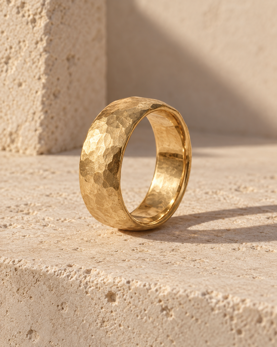 Illustrative textured wedding band on limestone